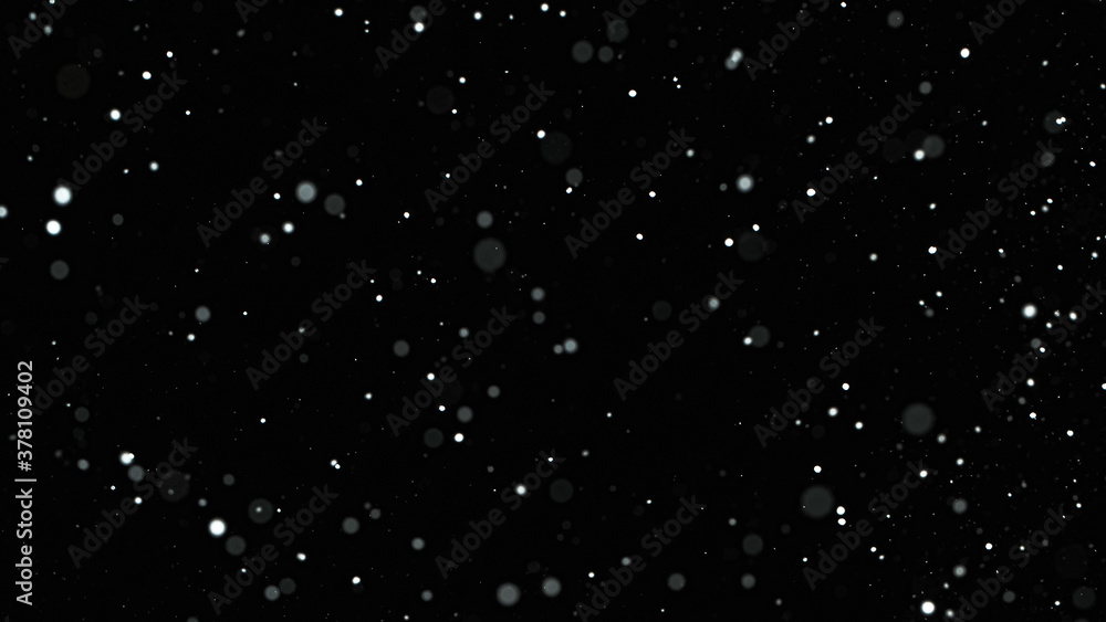 Falling snow on black background, close-up.
