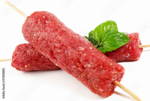 Raw Cevapcici Skewer Isolated on white Background