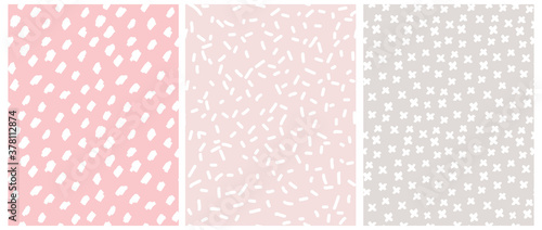Cute Pastel Color Geometric Seamless Vector Patterns. White Hand Drawn Spots and Crosses on a Gray and Light Pink Background. Lovely Infantile Irregular Doodle Print.