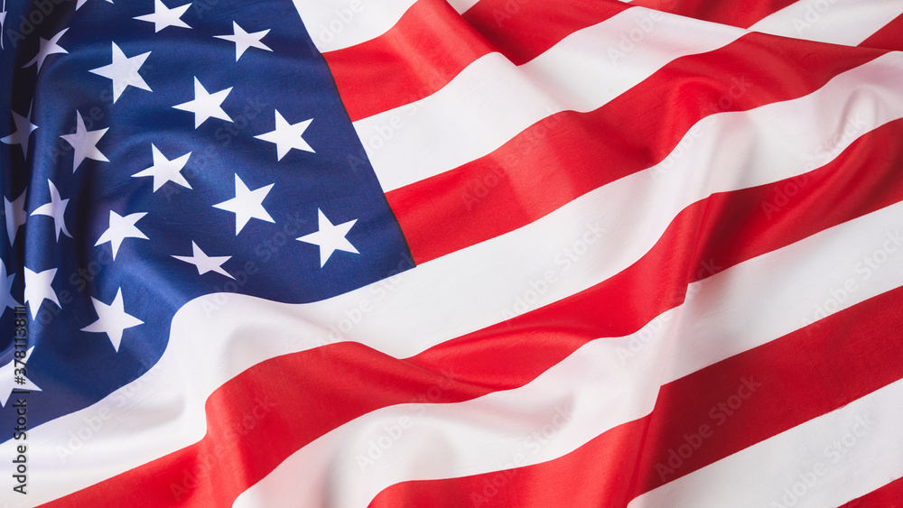 Fototapeta premium Close up of ruffled American flag. Satin texture curved flag of USA. Memorial Day or 4th of July. Banner, freedom concept