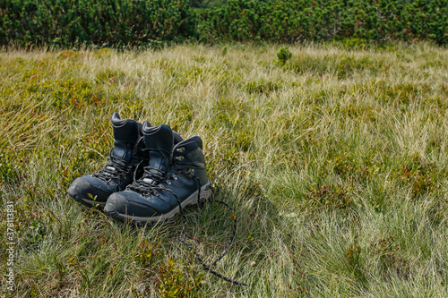 Fototapeta Naklejka Na Ścianę i Meble -  hiker boots on the mountain meadow