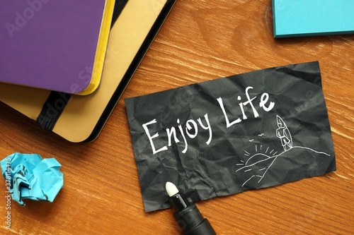 Financial concept about Enjoy Life with inscription on the piece of paper.