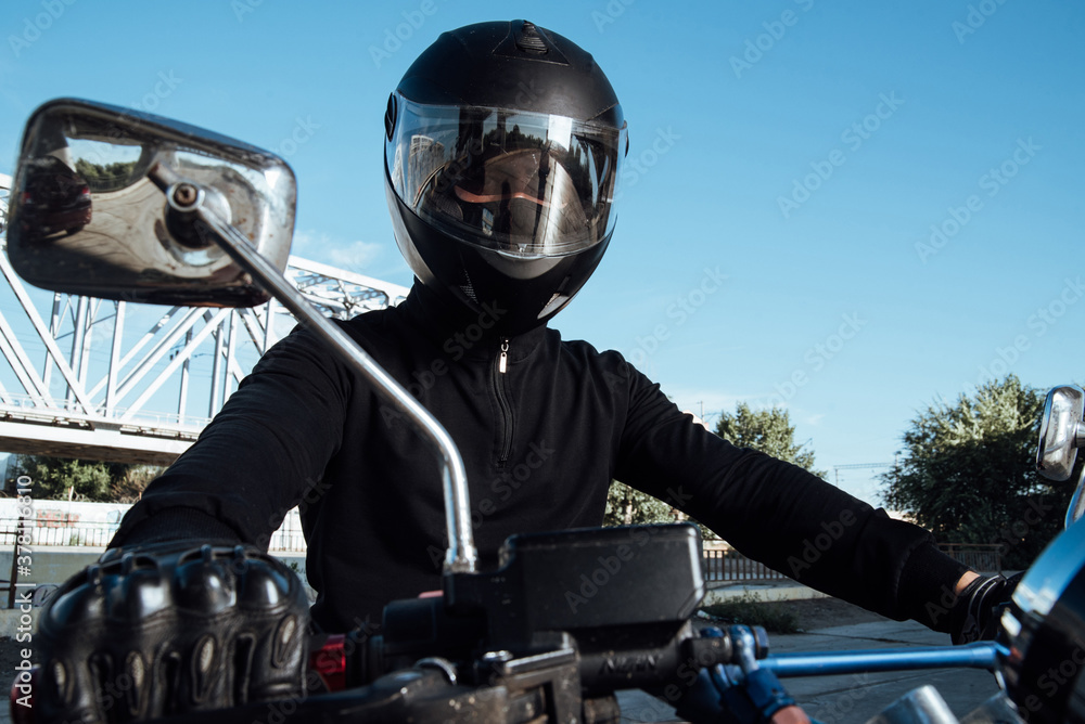 Man seat on the motorcycle.Motorcyclist in black helmet on a red bike Man seat on the motorcycle.Motorcyclist in black helmet on a red bike