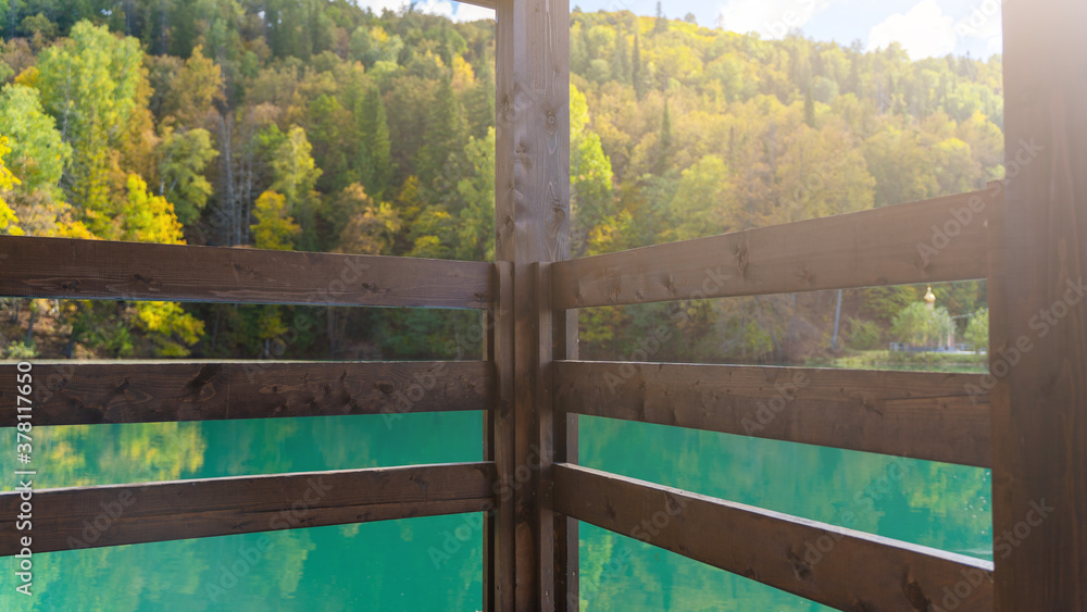 Fototapeta premium Blue mountain lake with a house. Beautiful autumn morning
