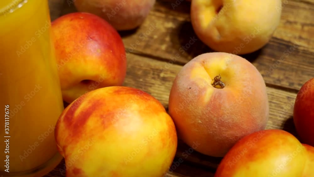 ripe peaches and a glass of peach juice on a table.close-up. ripe peaches and a glass of peach juice on a table.close-up.