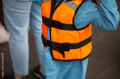 Life jacket on the child. Clothes for safe swimming. 