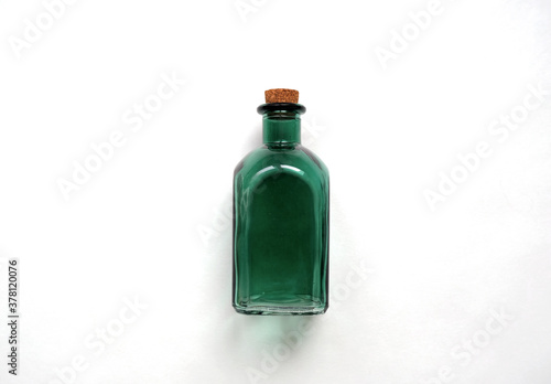 Canvas Print Old-fashioned green transparent glass bottle for medicine, essential oil, empty