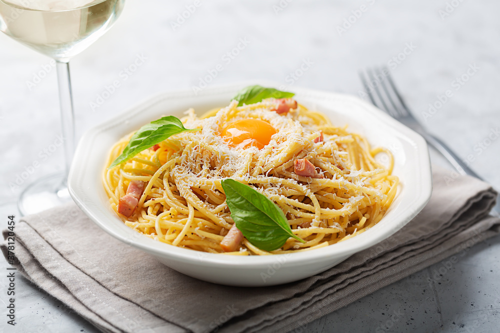 Italian pasta carbonara made with egg, hard cheese, cured pork guanciale or pancetta and black pepper, close up