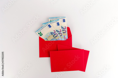 red envelope with euro money inside, christmas flat lay economy
