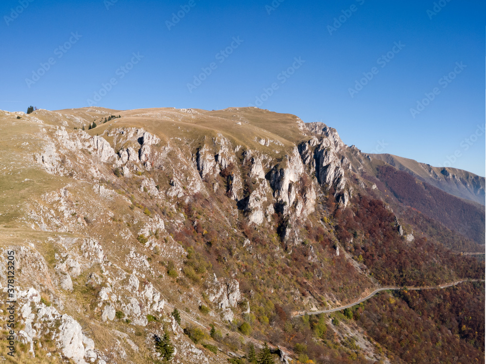 Scenic view of the steep rocky cliffs of Mount Vlašić in autumn during a sunny day. Scenic view of the steep rocky cliffs of Mount Vlašić in autumn during a sunny day.