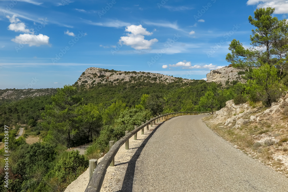 Curve on the road between mountains and forest in the Vauvenargues commune natural park, Provence-Alpes-Côte d'Azur region, Bouches-du-Rhône department, France