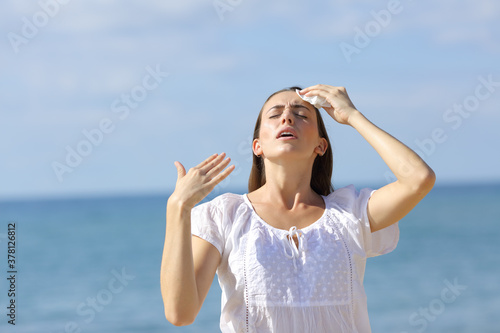 Stressed teen suffering heat stroke on the beach