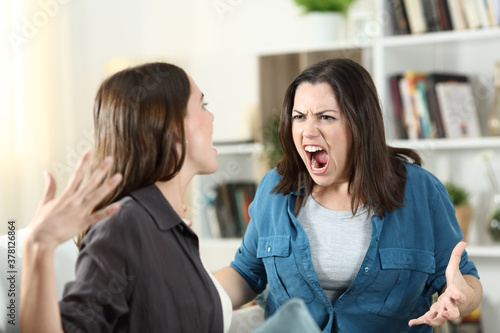 Two roommates arguing and shouting at home photo