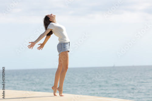 фотографія Excited woman with long legs breathing fresh air