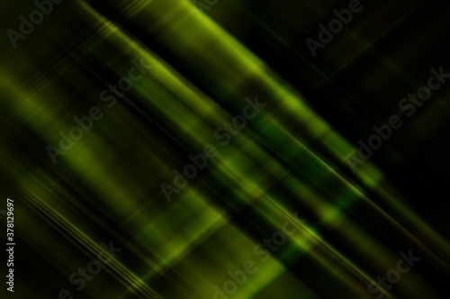Abstract background blurred green yellow rays light on black with the gradient texture lines effect motion design pattern graphic diagonal.