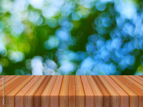 wood table and blur bokeh green background for product display