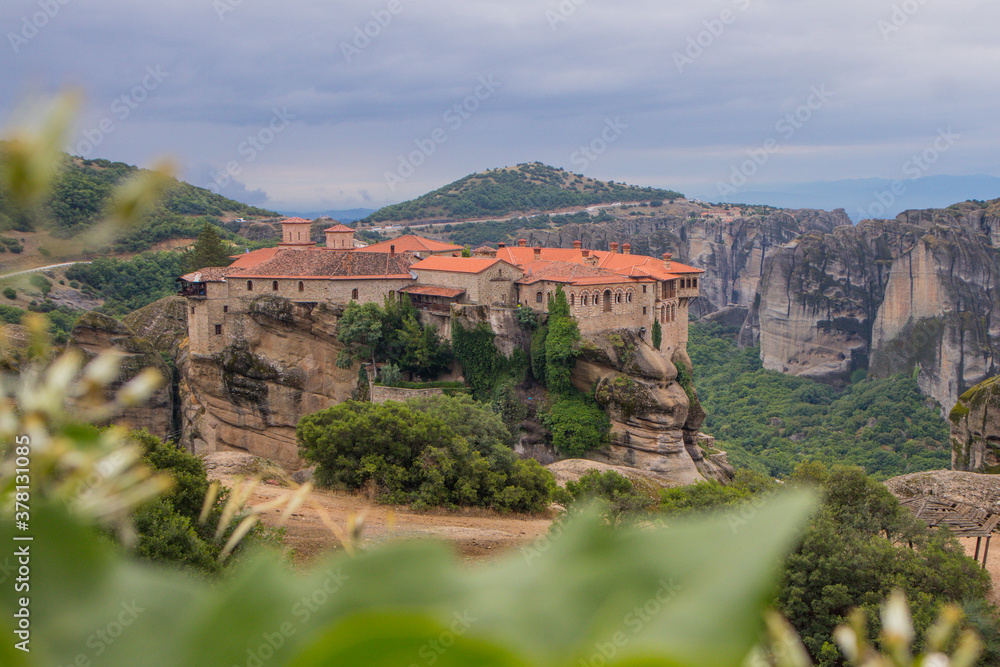 View of Varlaam Monastery. Beautiful scenic panoramic view, ancient traditional greek building on the top of huge stone pillar in Meteora,Thessaly, Greece, Europe on a cloudy day. View of Varlaam Monastery. Beautiful scenic panoramic view, ancient traditional greek building on the top of huge stone pillar in Meteora,Thessaly, Greece, Europe on a cloudy day.