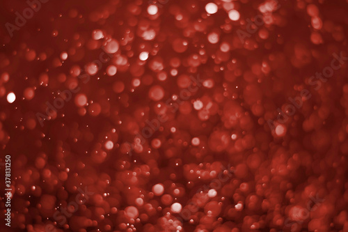 Red glitter vintage lights background. red bokeh on black background.