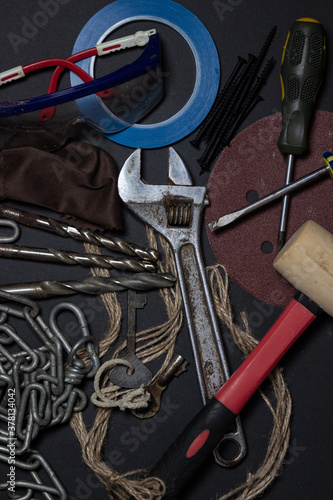 Working tools on a black background. Used and dirty work tools for home improvement or diy repair projects. Manual labor concept