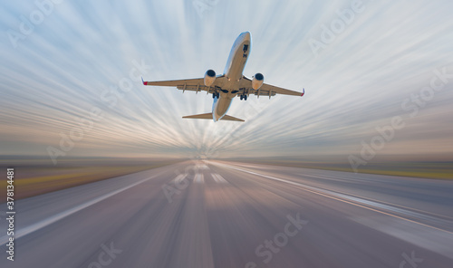 White Passenger plane fly up over take-off runway from airport with amazing white clouds © muratart