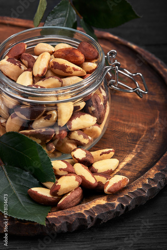 Open jar filled with Brazil nuts close up