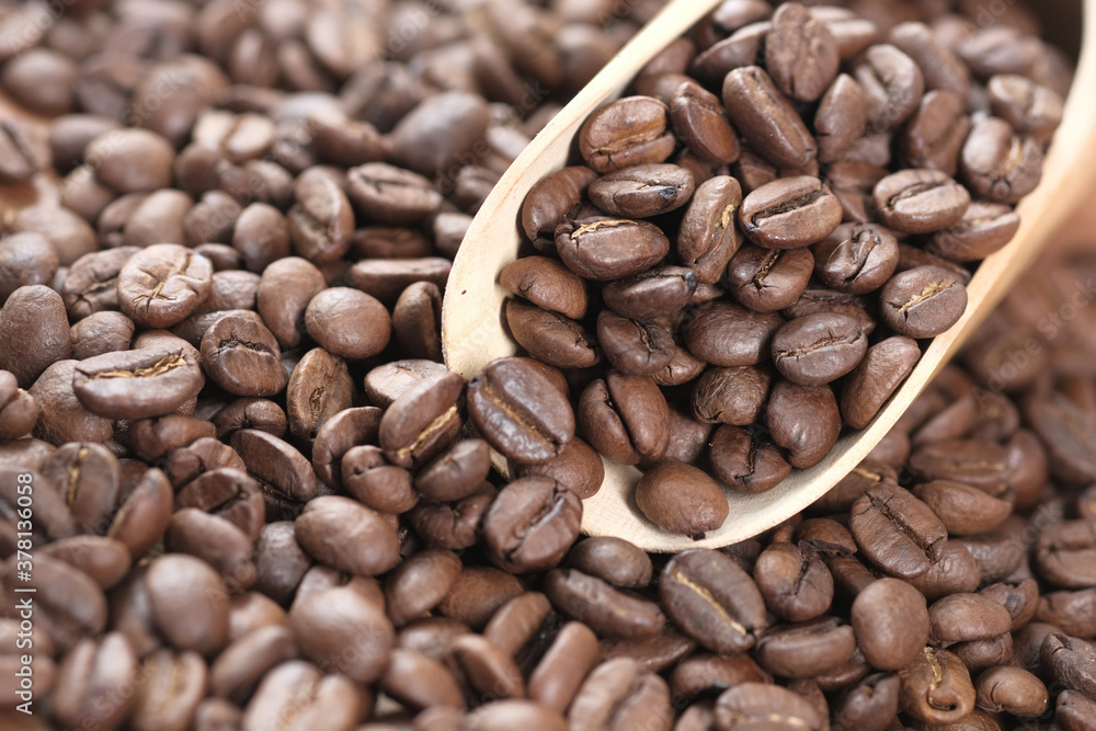 fresh coffee beans and spoon on table fresh coffee beans and spoon on table