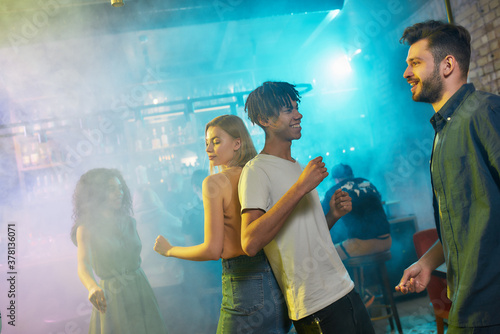 Group of friends enjoying evening, having fun while dancing together at party in the bar © Svitlana