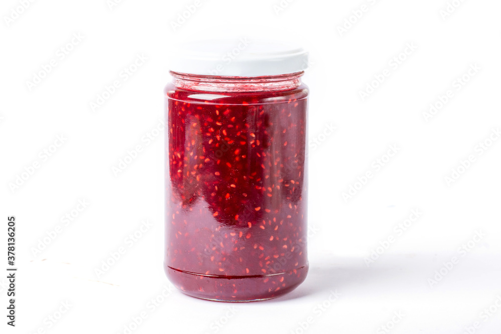 raspberry jam in a glass jar on a white background raspberry jam in a glass jar on a white background