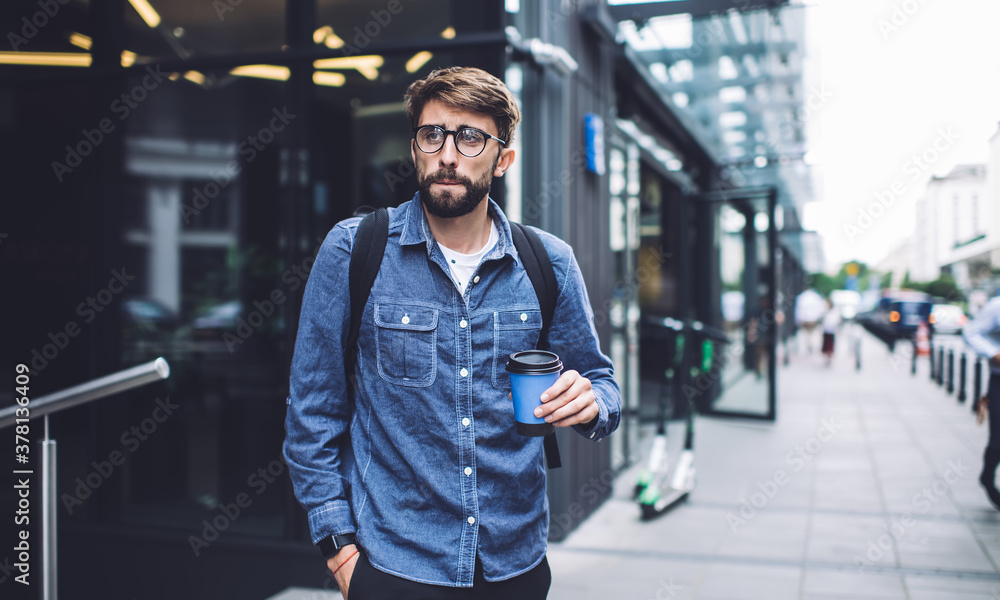 Thoughtful man with coffee on street pavement in afternoon Thoughtful man with coffee on street pavement in afternoon