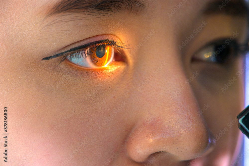 Naklejka premium woman looking at eye test machine in ophthalmologist. ophthalmologist. medical, health concept.