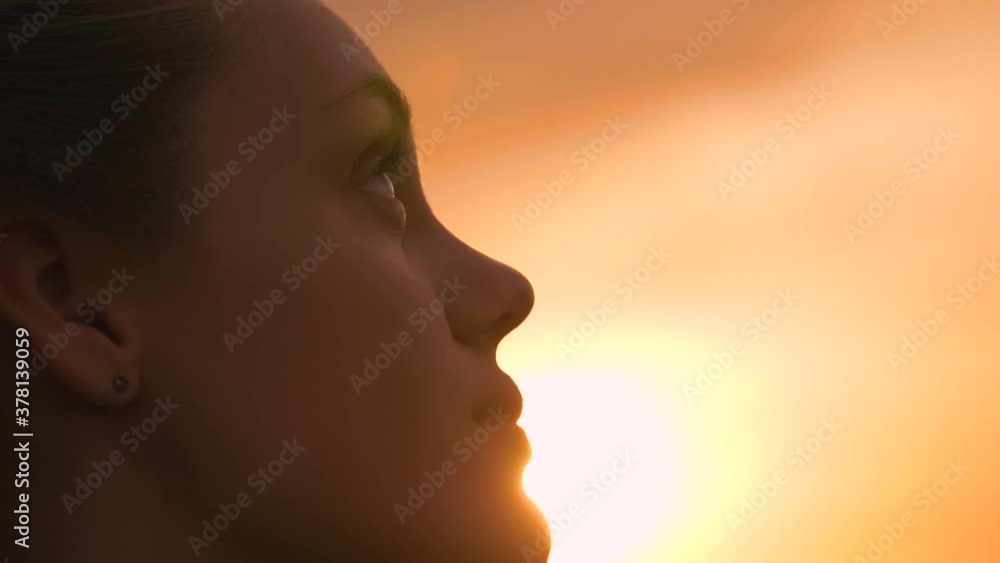 Portrait of a happy young teenager girl on the street. The girl dreams with pleasure with her eyes closed. The lady feels free, successful, ready to start the day, move forward. Portrait of a happy young teenager girl on the street. The girl dreams with pleasure with her eyes closed. The lady feels free, successful, ready to start the day, move forward.