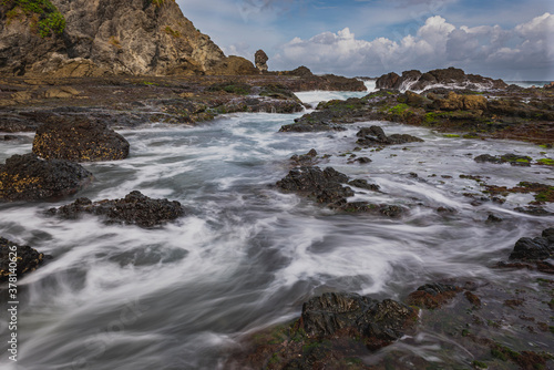 Sea water flowing view in Siung volcanic rock beach, Java Island, Indonesia