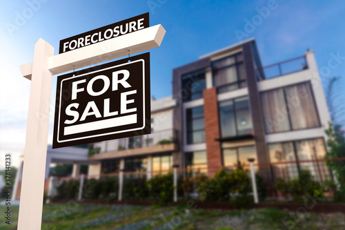 Black Foreclosure Home For Sale Real Estate Sign in front of a contemporary glassy modern house. photo