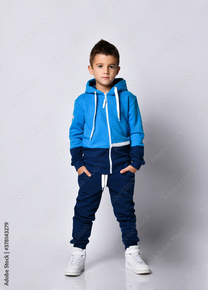 Naklejka premium Little boy model in sports tracksuit portrait