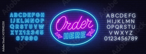 Order here neon sign on brick wall background. White and blue neon alphabets.