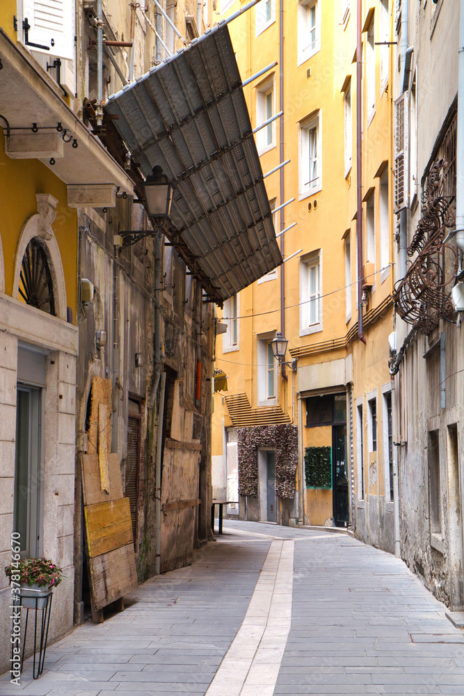 Old architecture and narrow street of historic Trieste, Italy