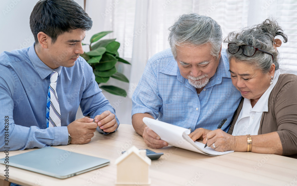 Asian senior couple making sign contract to buy new house. Asian senior couple making sign contract to buy new house.