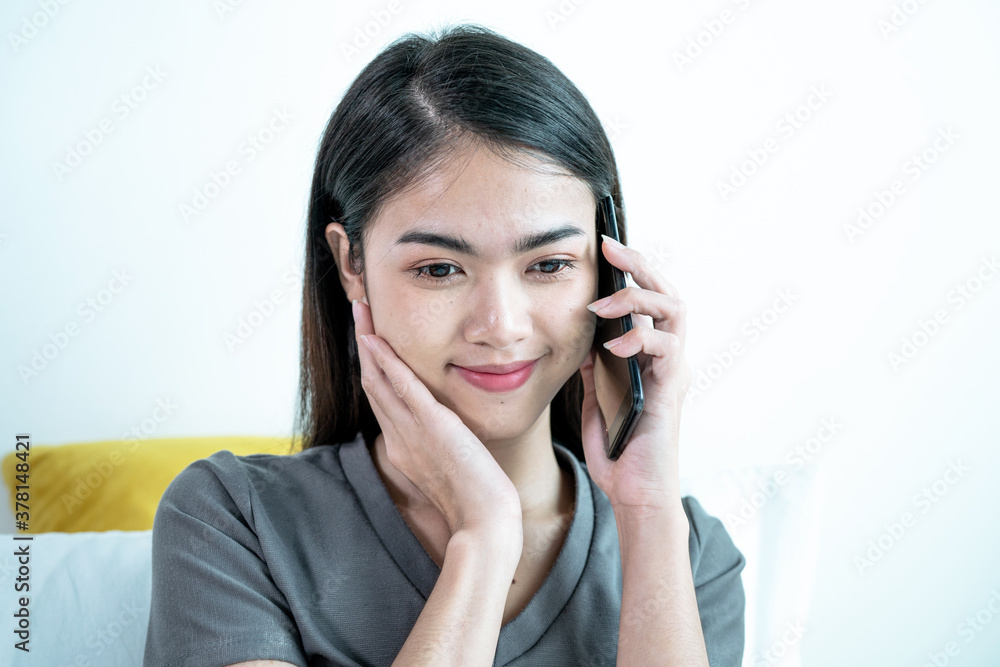 Young Asian woman uses a cell phone to call her boyfriend. Young Asian woman uses a cell phone to call her boyfriend.