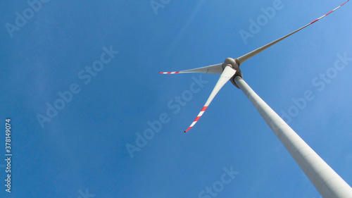 Windmill against sky. Bottom view. Clean energy concept © Галя Дорожинська