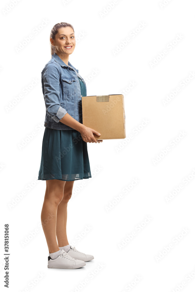 Full length shot of a young female carrying a cardboard box - obrazy, fototapety, plakaty 