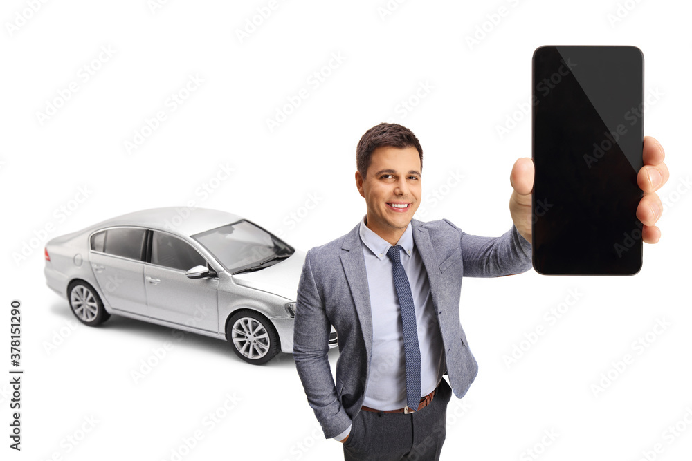 Professional young man with a silver car holding a mobile phone Professional young man with a silver car holding a mobile phone