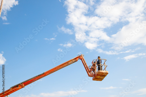 man working at heights with lifting platform.