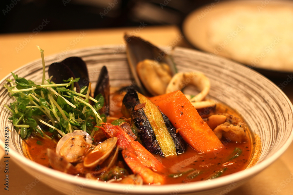 Close up of a bowl of delicious curry seafood, Japanese food, soft focus Close up of a bowl of delicious curry seafood, Japanese food, soft focus