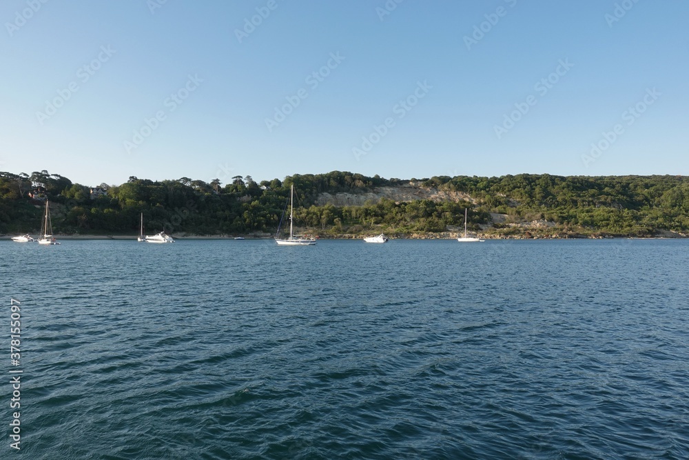 Boats and sailing yachts anchored in the bay just off the Needles at Totland Bay, Isle of Wight UK