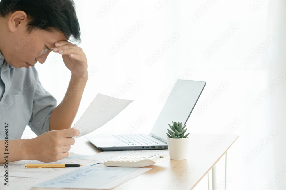 Frustrated stressed business man checking chart and diagram report Frustrated stressed business man checking chart and diagram report