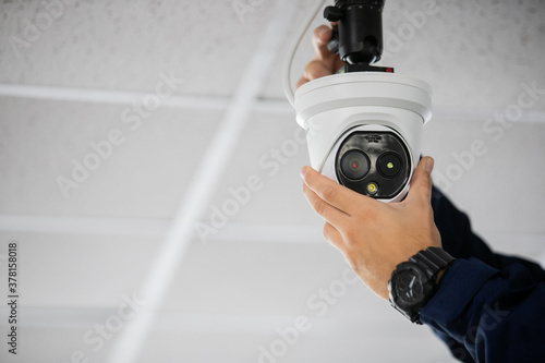 Technician installing IP wireless CCTV camera by screwed for home security system and installed photo