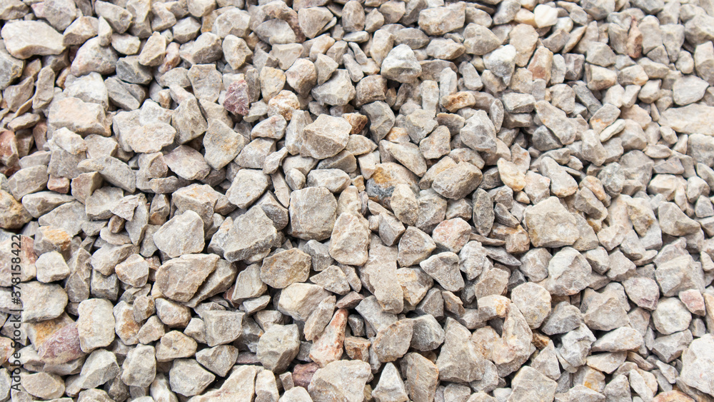 Top view of the Pebbles on the walkway.stone grit scree on floor.stone grit scree background. Top view of the Pebbles on the walkway.stone grit scree on floor.stone grit scree background.