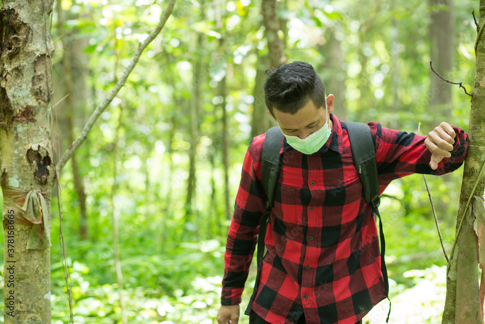 Asian man Hiking Forest survey wearing protective mask In public on nature background beautiful