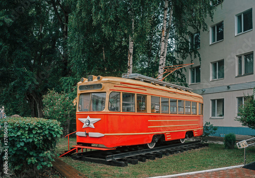 Vintage Soviet tram among greenery in Perm, Russia.