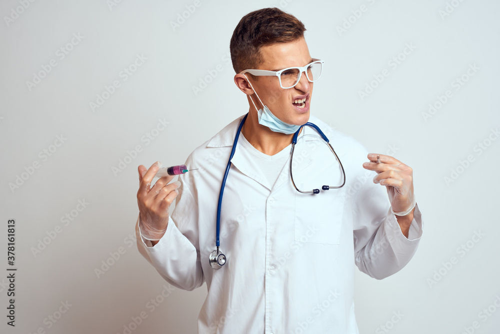 doctor in a medical gown with a stethoscope and glasses on a light background cropped view portrait doctor in a medical gown with a stethoscope and glasses on a light background cropped view portrait